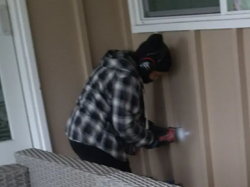 Professional electrician installing an exterior outlet in Fairport